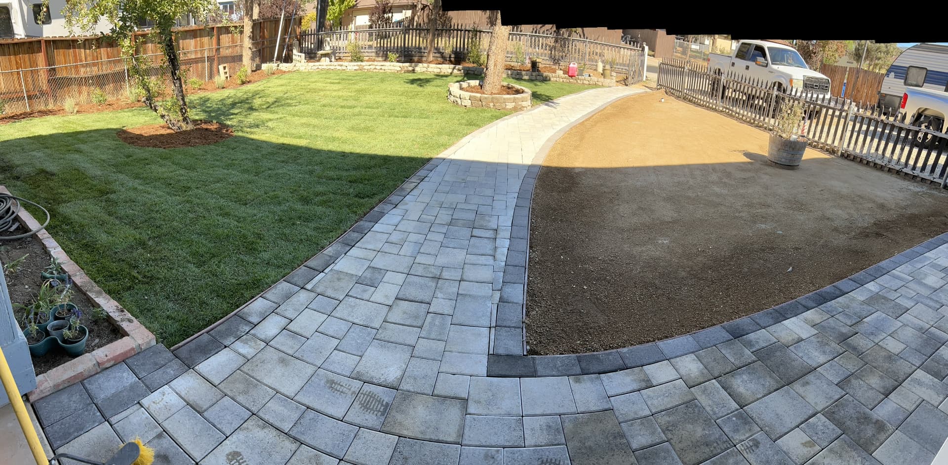 Paver walkway and driveway with new sod lawn and planting beds
